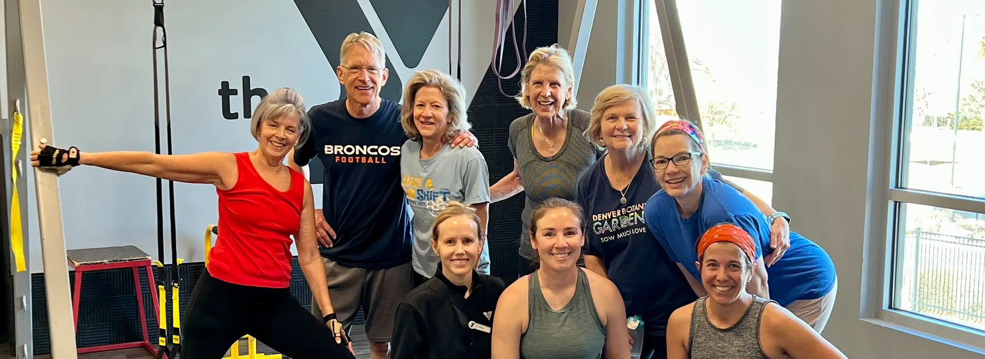 adults in exercise clothes posing for photo